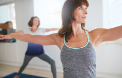 Fitness Trainer Doing The Warrior Pose At Yoga Class